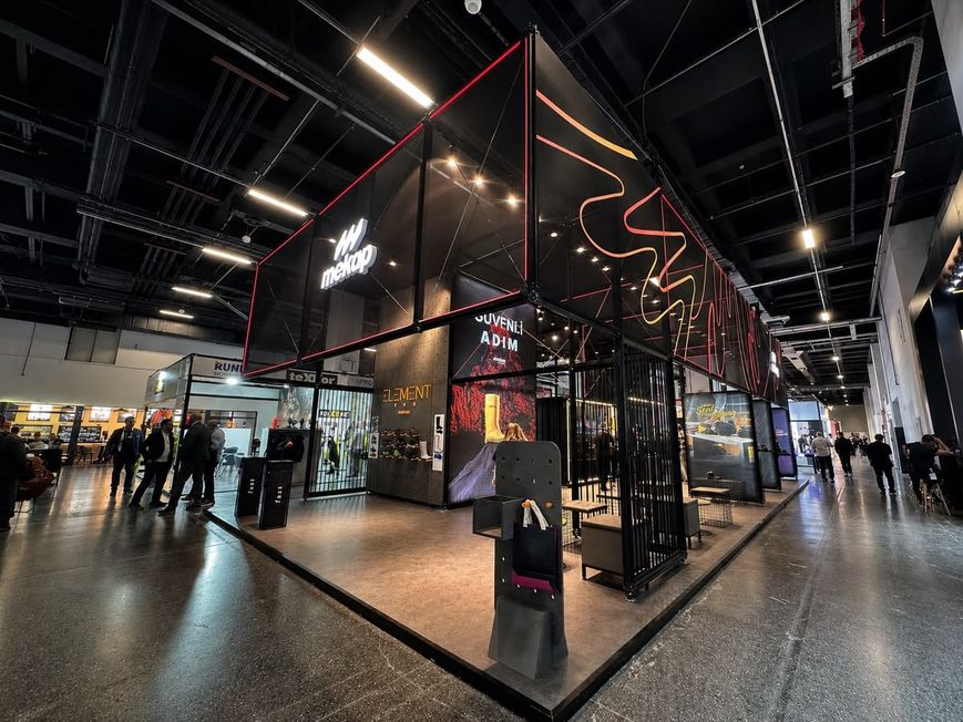 Schwarzer Messestand mit roter Neonlinie als Konturbeleuchtung